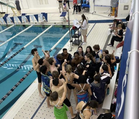 Warriors on the Warpath: Swim team gathers to cheer before the meet starts.