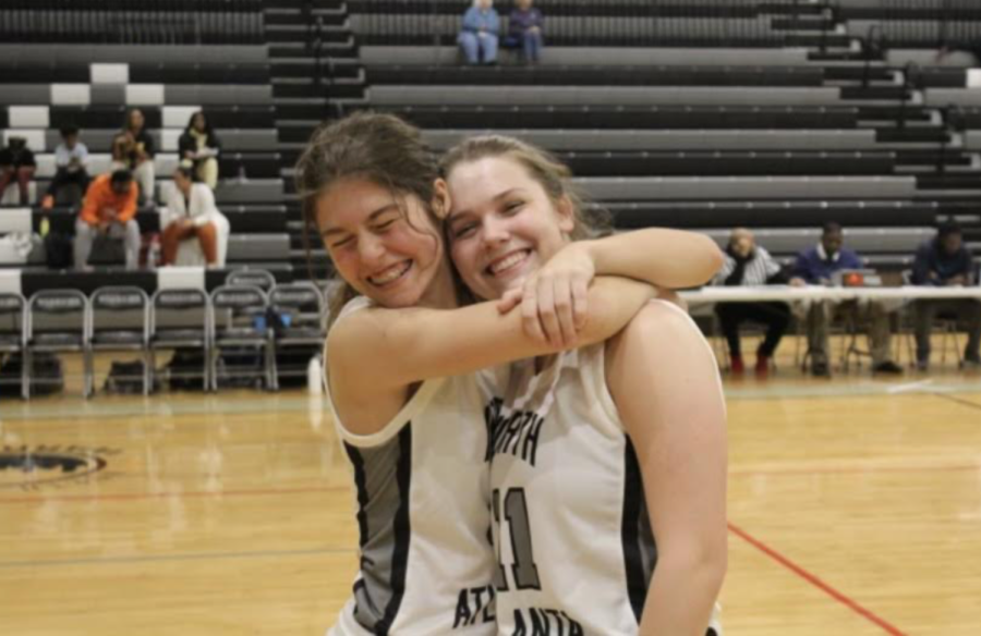 All Smiles: Lanier Beckham and teammate Siena Schettino hug it out after a big win. 