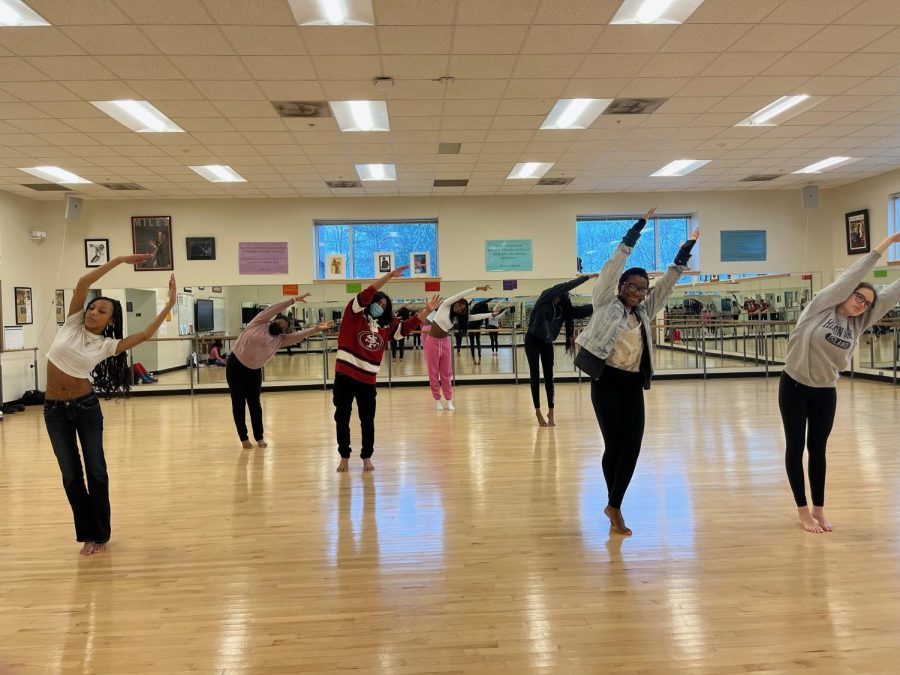 Prepping for Perfection: Dancers in dance 3 work to warm up before they start the main part of class for the day.