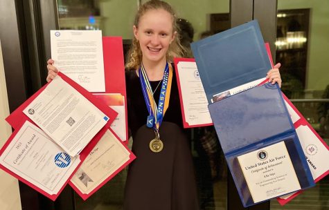 Winning Dub: Ella Sipe proudly poses with all of the awards she won after attending the district science fair.
