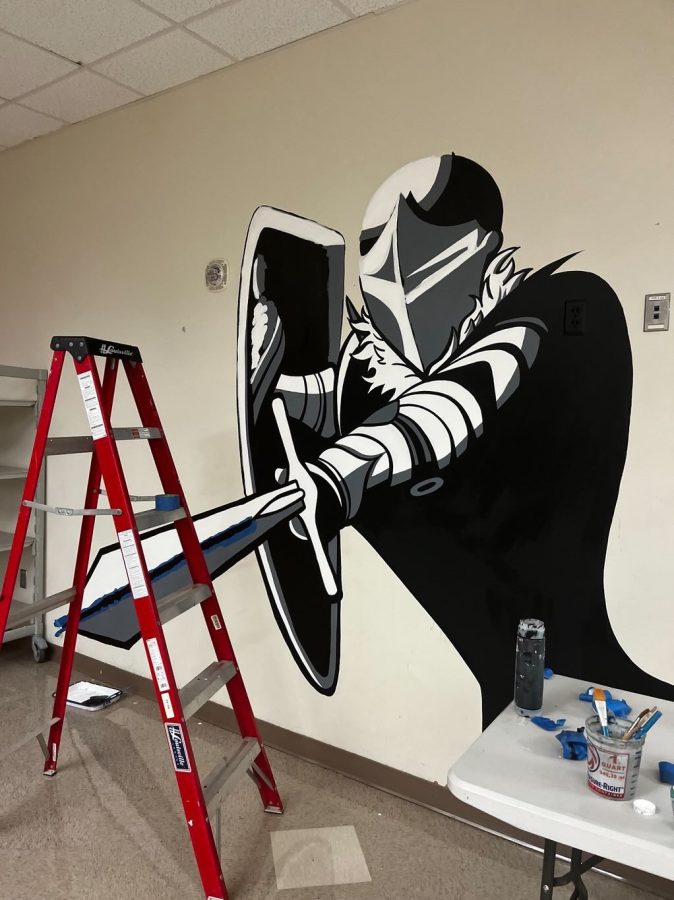 Mural, mural on the wall… who are the most talented dubs of them all? Seniors Anna Rohn and Ella McCabe diligently completed the Warrior cafeteria mural over a 3 day weekend.  