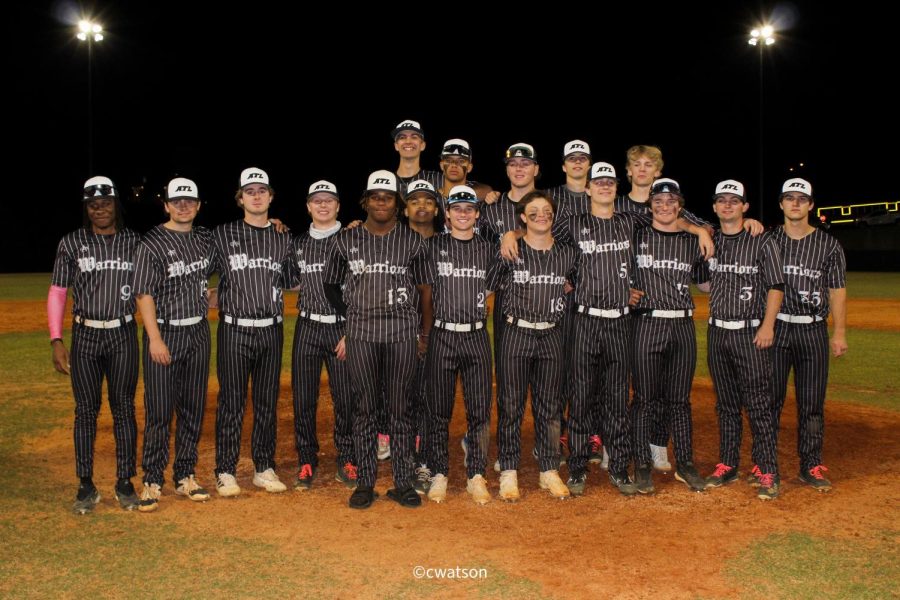 Pushing for the Dub: 17 senior baseball players rake to the field on April 27 to prove the previous years loss moot and achieve a state playoff victory.