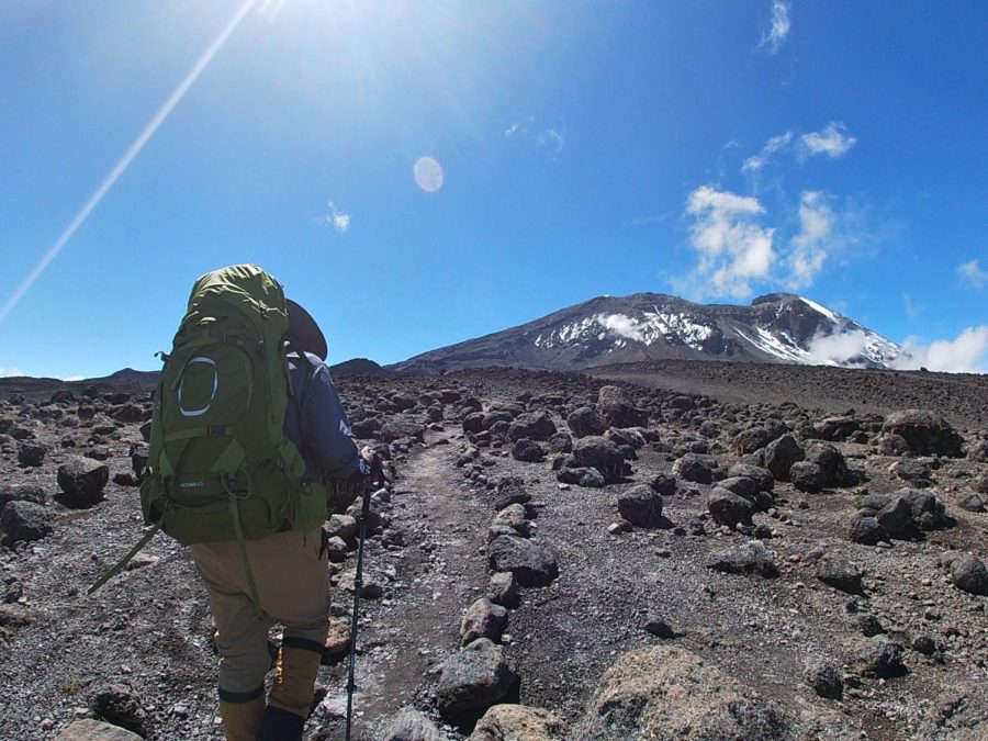 Mount Kilimanjaro at 15,000 Feet: The icy 19,341 foot peak rises above the rocky alpine desert climate zone. Experienced mountain guide Kombe leads Ellas group on an acclimation hike. 