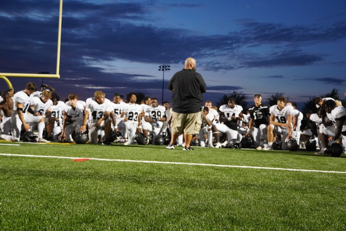 Coach Aull addresses the team after the fall scrimmage in a 19-13 victory over Westminster.