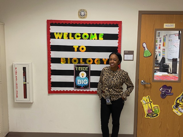 Jessica Snead in front of her 4th floor classroom. Snead pursues excellence in her daily habits, fueled by a passion to learn, teach and bring enthusiasm to the classroom.