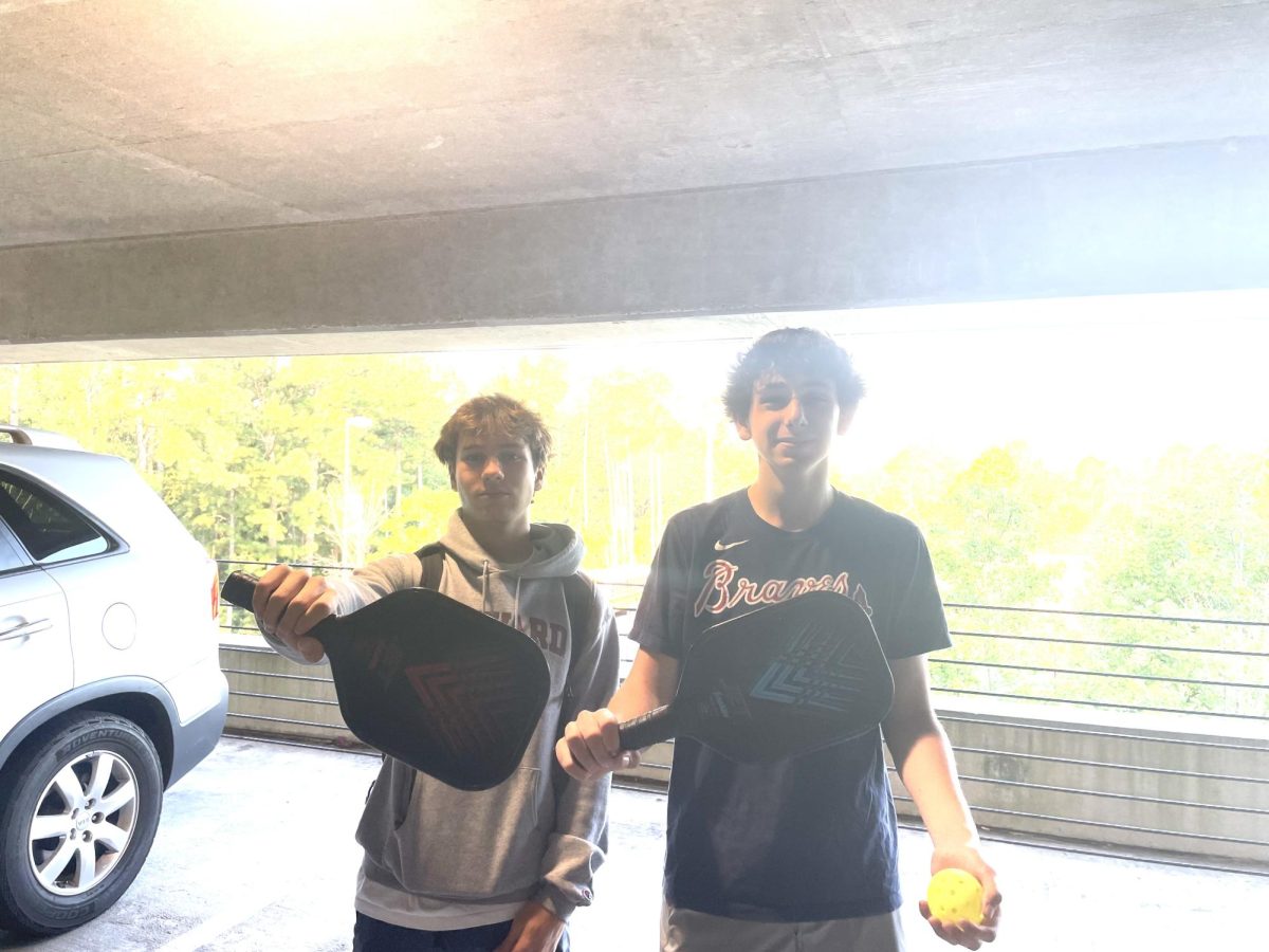Juniors Tucker Heaton and Alex Katz, both avid pickleball enthusiasts, show off their paddles of choice.