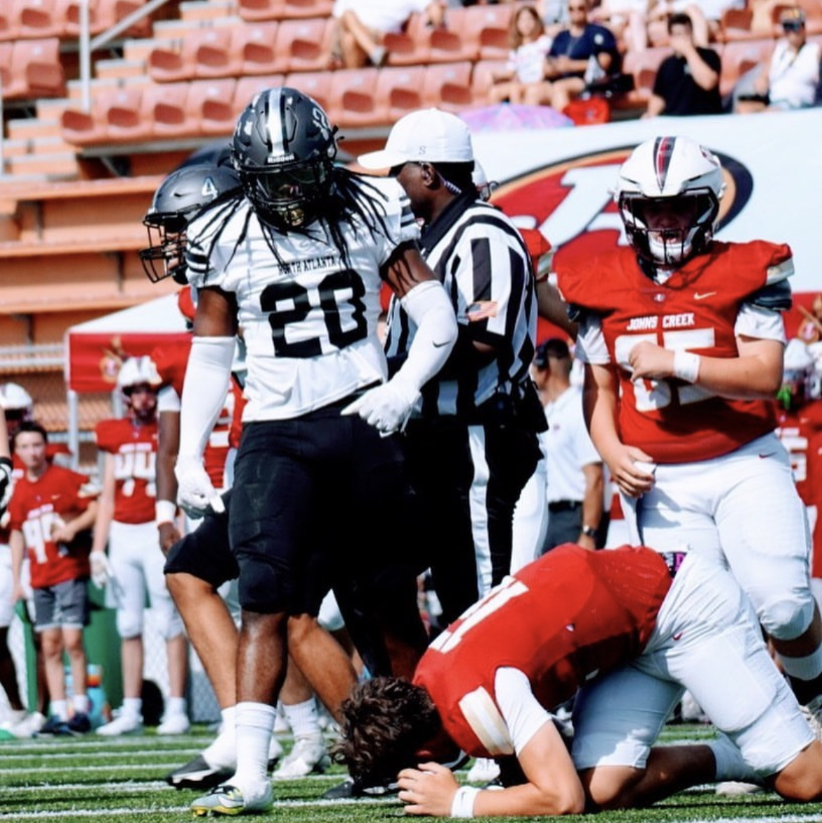 Senior linebacker Quinten Fields stands over the John’s Creek quarterback after a defensive stop