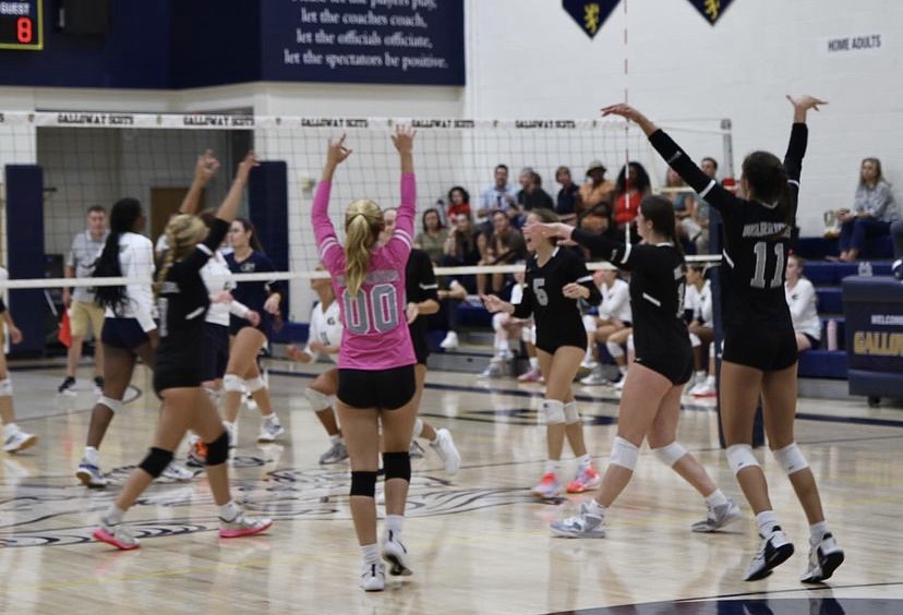 The Warriors Volleyball Team ignites a celebration after an electric point