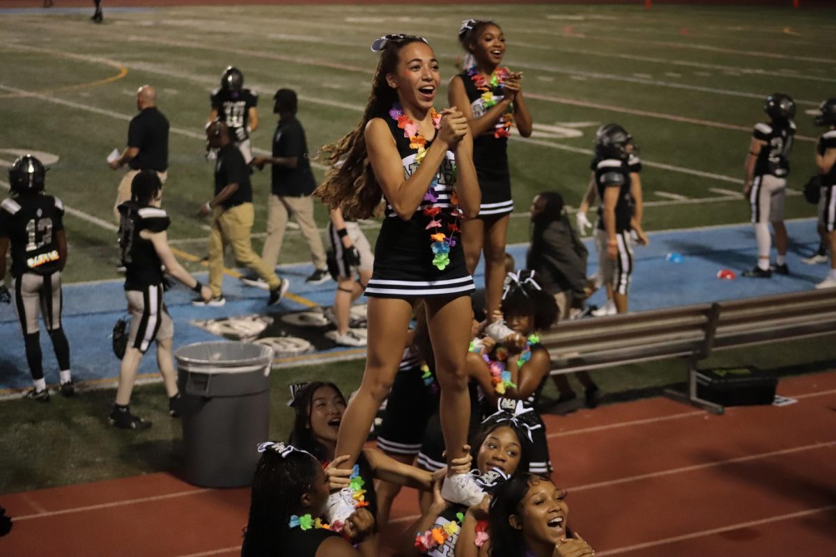 Go Fight Win: The North Atlanta cheerleaders proudly perform their polished routine to kick off the first game of the season.