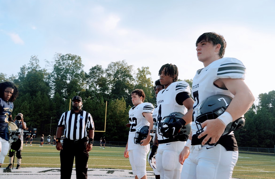 First year starter and team caption- #4 Xavier Ellison meets Drew at midfield for the coin toss