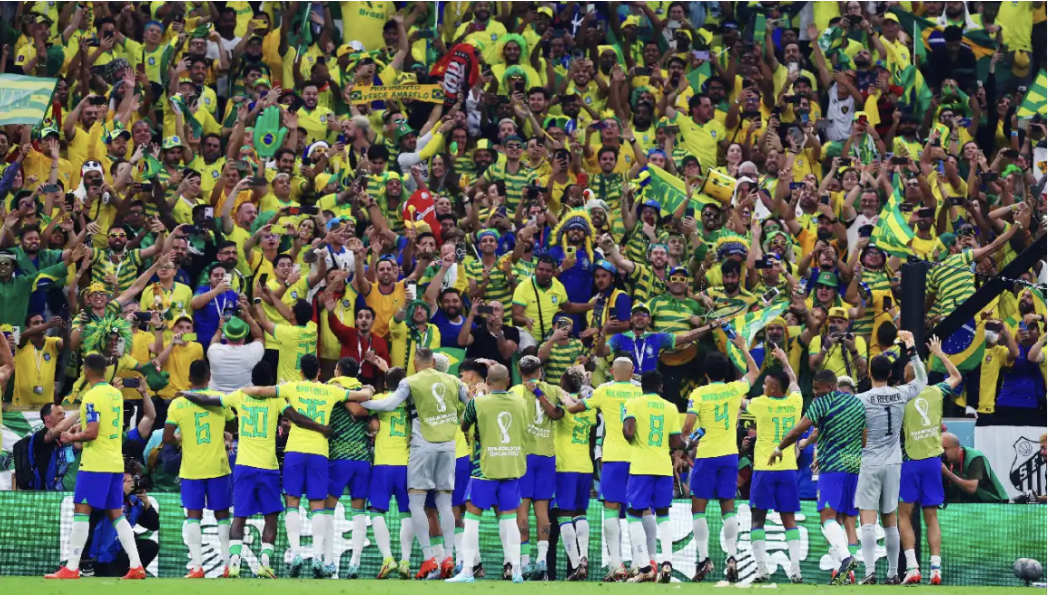 Goal Scoring Greatness: Players celebrate as the fans explode with jubilation after a game-sealing goal