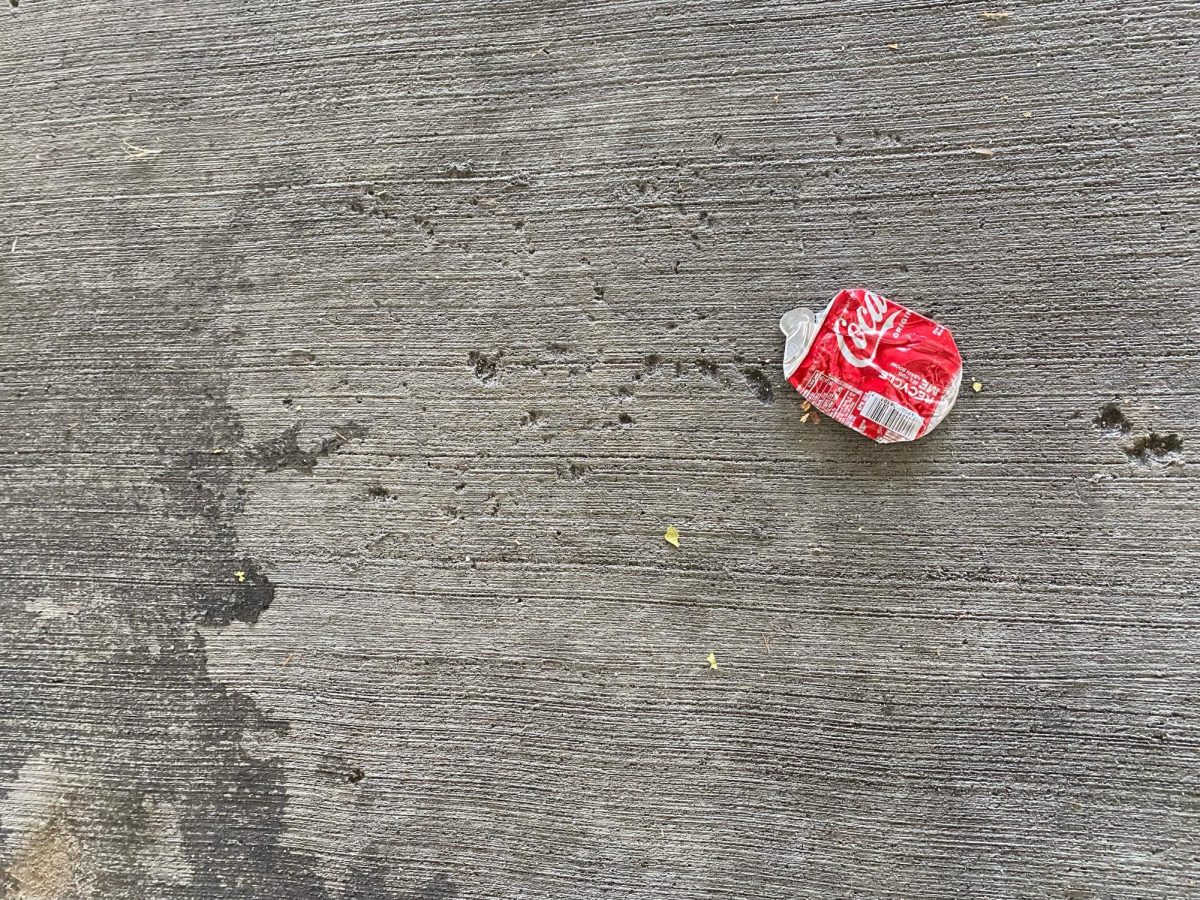  A crushed can of Coca-Cola sits on the parking deck.