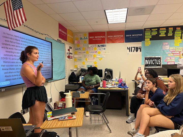 Yearbook leader Lizzie Hart directing a meeting with the captive audience of her staff