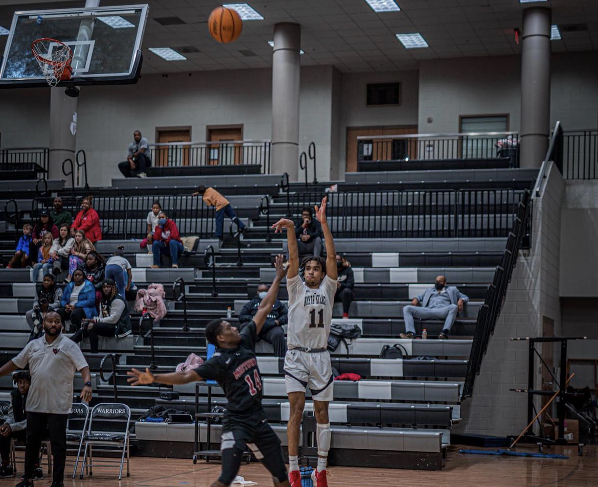 Its raining threes: Josh Griffith (24) rises up to hit a three pointer over an opposing player