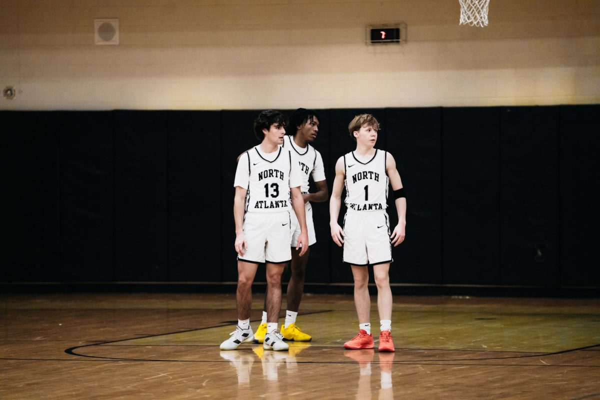 Warrior basketball players take a rest during free throws.