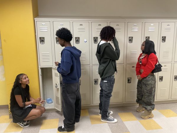 Between Bells: Zakaiya Rich, London McKenzie, Joshua Blackwood-Hightower, and Christian Head share a laugh at their lockers.