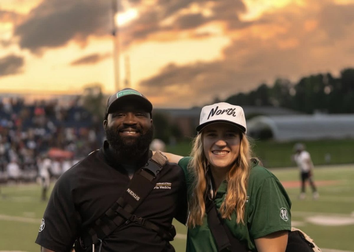 Athletic trainers Andrea Devis and Demetre Ledlum taking charge on the sidelines under the Friday night lights. 