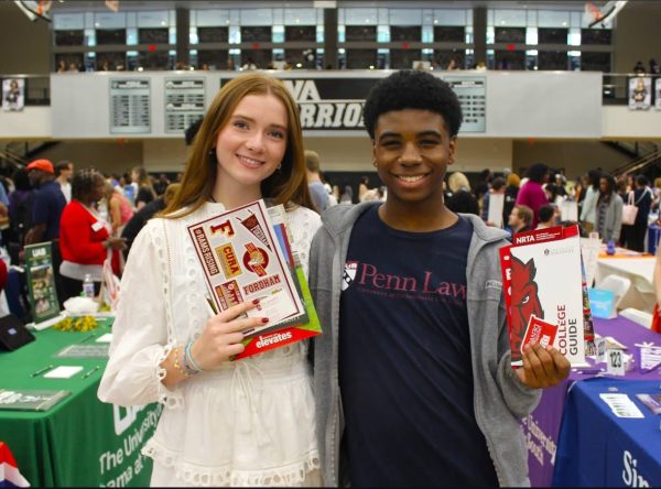 Seniors Audrey Khayat and Mekhi Marks smiling big with their college brochures 