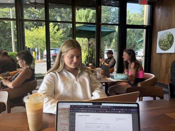 Studying at Starbucks: Amidst the smell of coffee and croissants, junior Elizabeth Adams completes her school work.