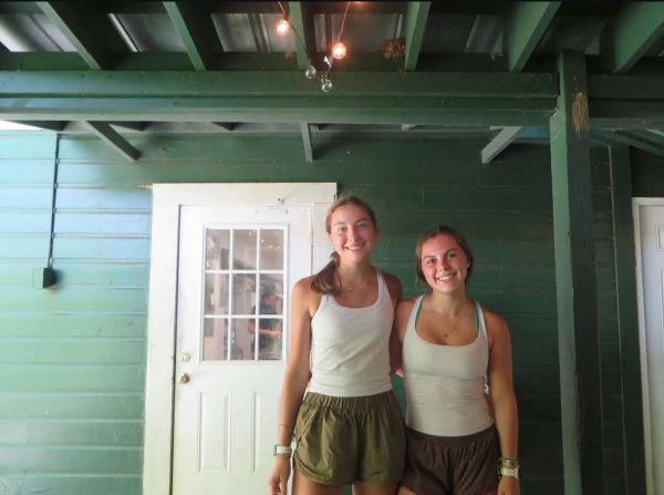 Co-counselors: Juniors Emily Shull and Blair Carter standing in front of their cabin at Camp Evergreen.