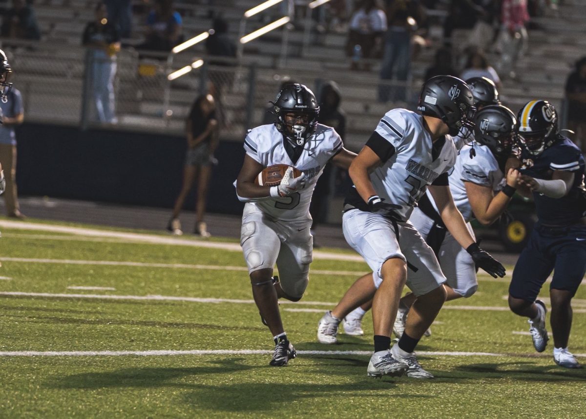 Cayden Edwards hustles behind his lineman for his second touchdown of the game.