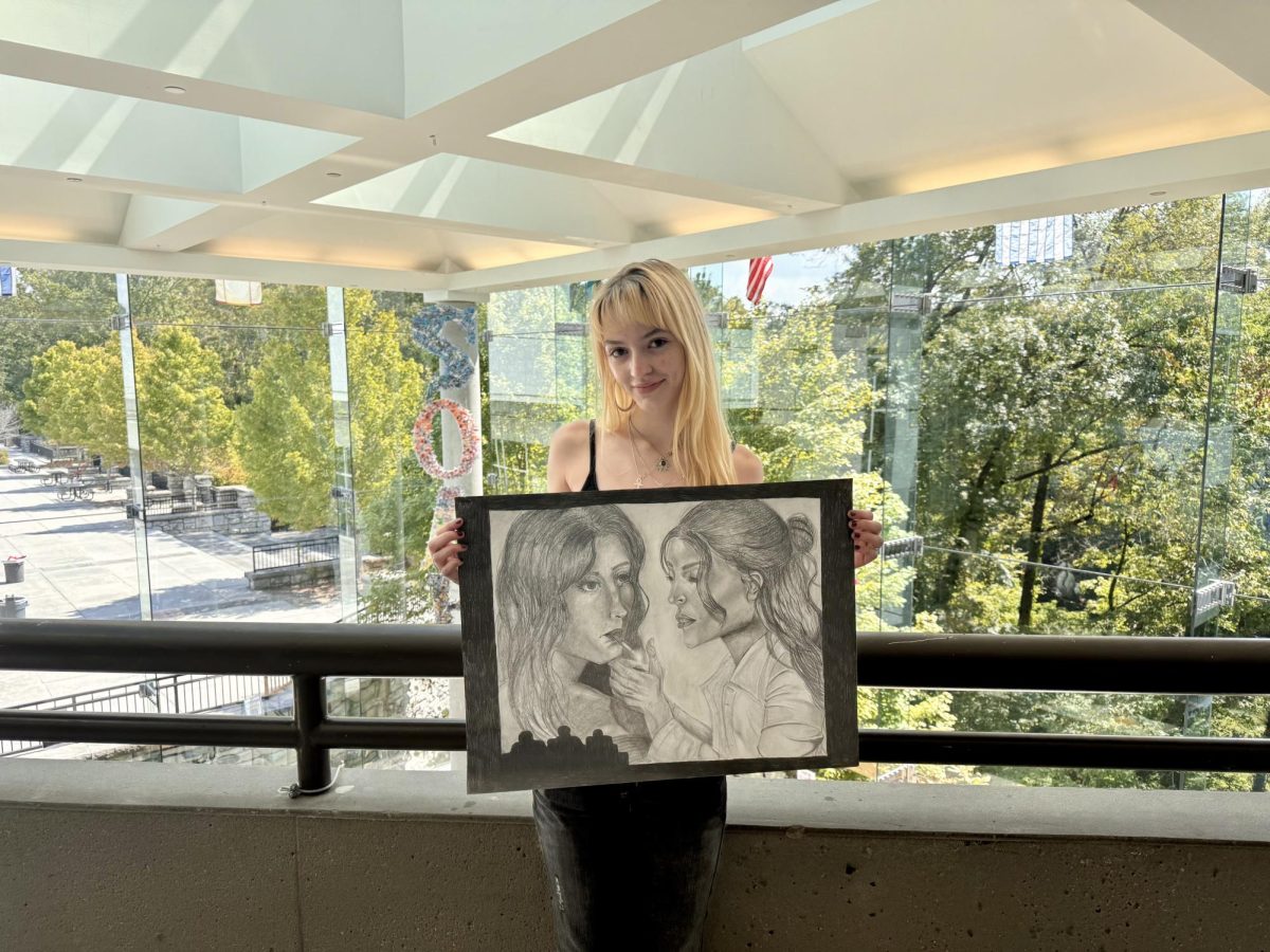 National Art Honors Society president, Julia Burnette, showcases one of her newest pieces for the IB Visual Arts program. 

