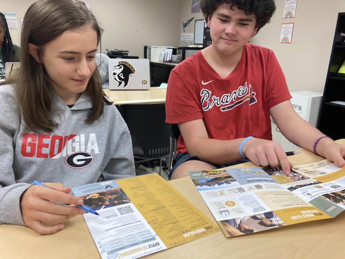 Impressive Interest: Juniors Frances Paulic and Franklin Pickens peruse the Vanderbilt brochure at the CCC representative visit.
