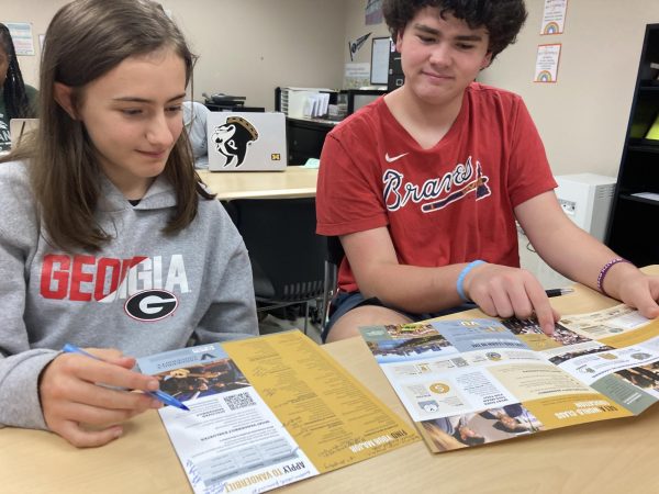 Impressive Interest: Juniors Frances Paulic and Franklin Pickens peruse the Vanderbilt brochure at the CCC representative visit.