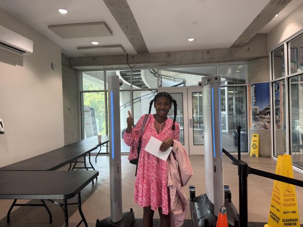 Safe and Secure—Sophomore Cali Barbour stands in the new security vestibule in front of the Evolv metal detectors.