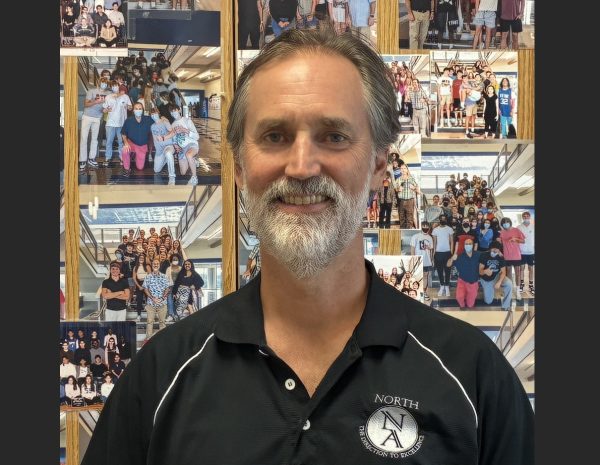 On Senor William's door are photographs of his classes dating back to his earliest years. Above: Senor posing before his famous picture cabinet.