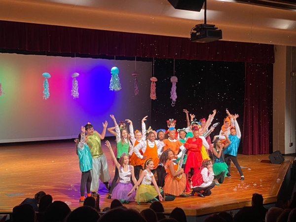 Under the Rainbow Lights: Sutton Middle School students beam with joy as they bring their scene to a vibrant conclusion.