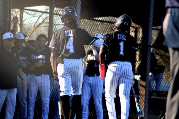 Seniors Bray Hill and Sam Kunz celebrate after securing the lead against North Forsyth.