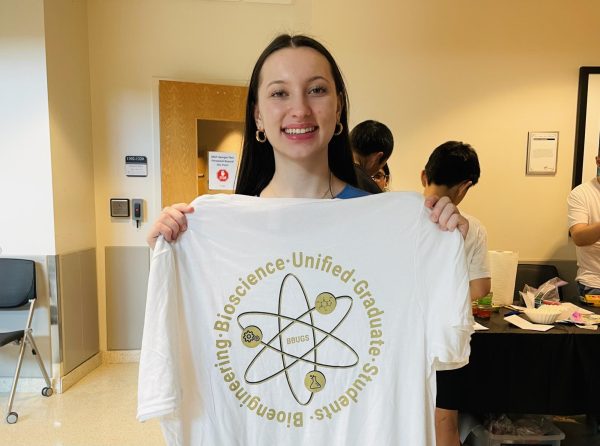 Sophomore Beatrice Reichert holding up one of the offered T-shirts at the Atlanta Science Festival.