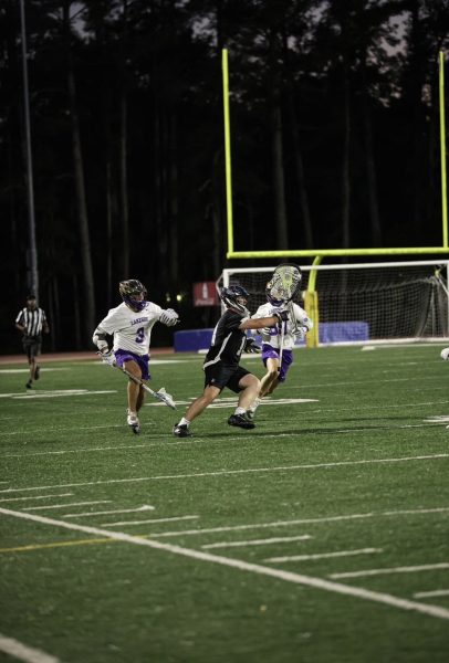 Brian Whittenton splits two defenders as he clears the ball past the defense.